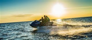 Family Riding Jet Boat at Sunset
