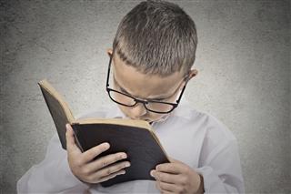 Boy having difficulty to read text vision problems