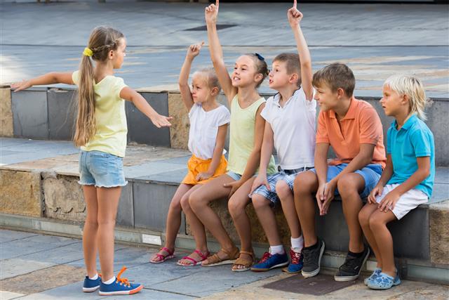 Kids playing charades outdoors