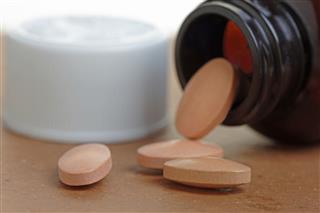 Statins or Generic Tablets in Close Up with Bottle