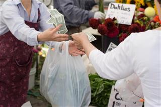 Paying cash for fresh produce at farmers market