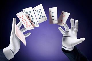 High contrast image of magician making card tricks