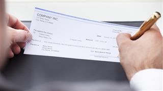 Businessman Filling Blank Cheque