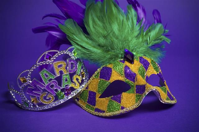 Mardi Gras mask and crown on a purple background