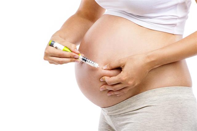 Pregnant woman with syringe