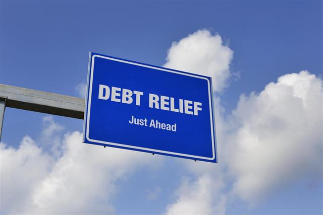 Debt Relief Just Ahead Road Sign with Clouds and Sky