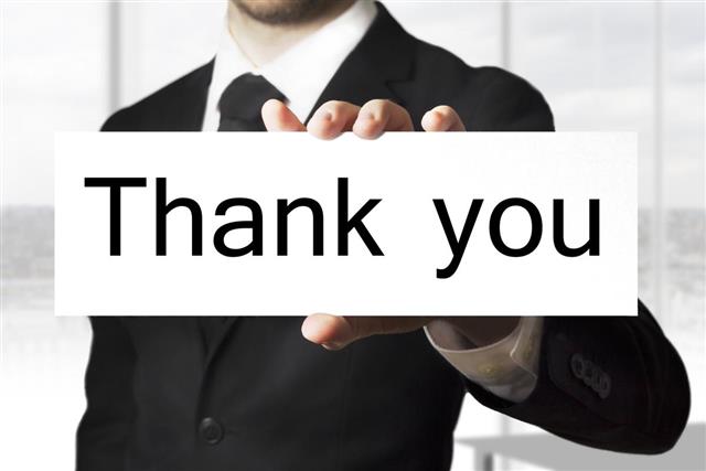 Businessman holding sign thank you