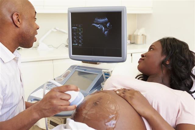 X-ray technician performing a 4D Ultrasound Scan on woman