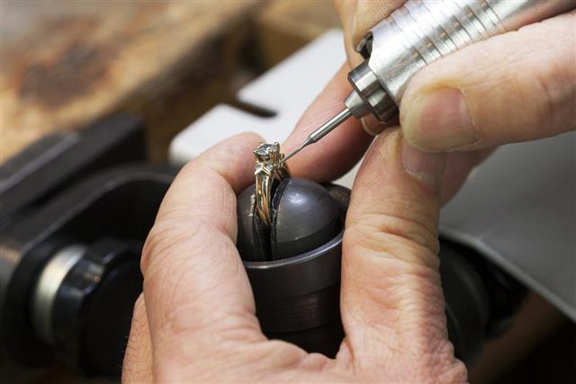 Close up of a jeweler's hands doing a repair
