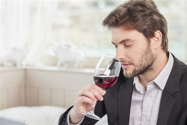 Young well-dressed man is relaxing in restaurant