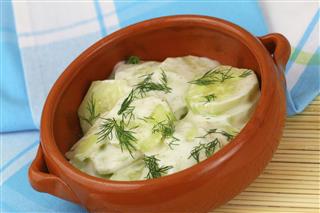 Cucumber salad with sour cream and fresh dill in bowl