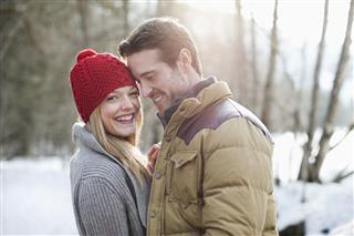 Smiling Couple In Snowy Woods