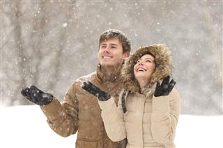 Couple Watching Snow In Winter