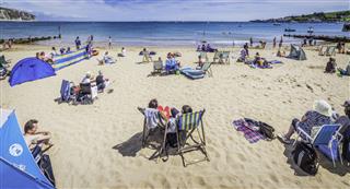 Seaside Sunbathers Families And Tourists