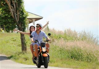 Happy Couple On A Scooter