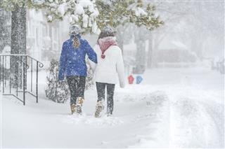 Two Teenager Girls Under Snowfall