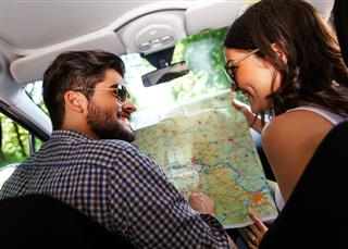 Couple With A Map In The Car