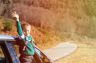 Happy Little Boy Travel By Car