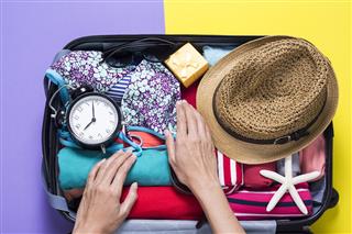 Woman Packing A Luggage