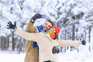 Tourists Making Selfie In Snow Forest