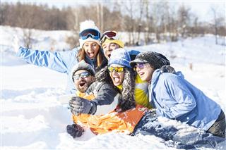 Friends Laughing And Making Selfie On Snow