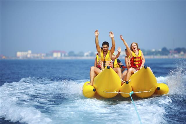 People Having Fun On A Banana Boat