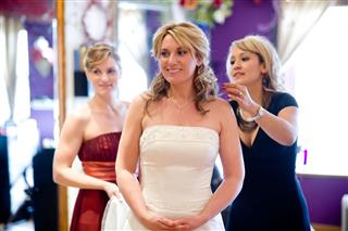 Bride With Bridesmaid And Salon Professional
