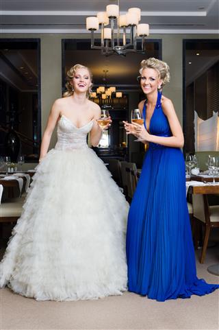 Bride And Her Bridesmaid In A Restaurant