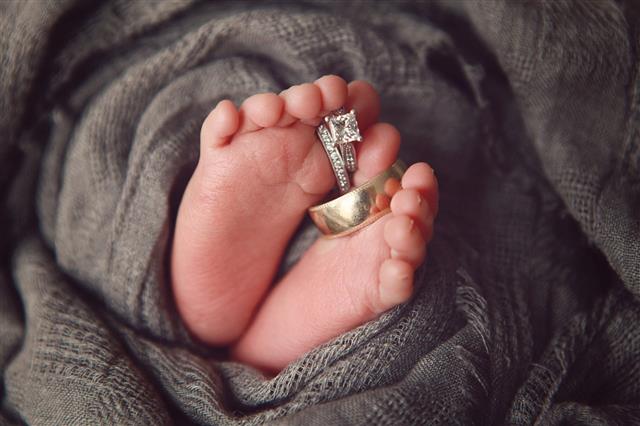 Wedding Rings Around Newborn Toes