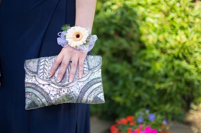 Girl With A Corsage Holding A Clutch Bag