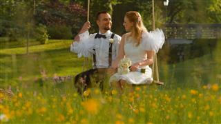 Bride And Groom Sitting In Park