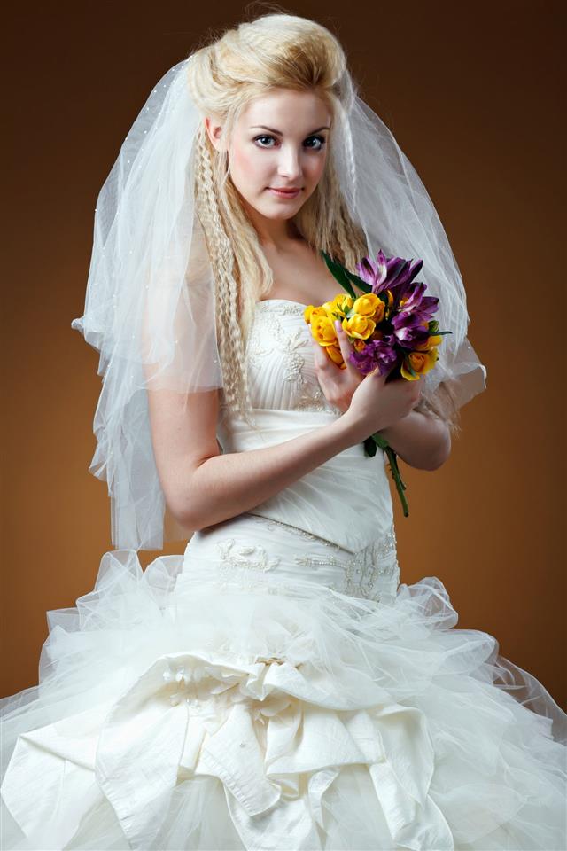 Blonde Bride With Bouquet Of Flowers