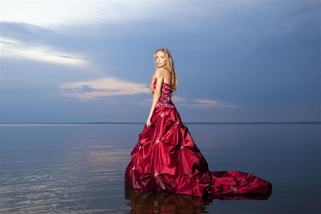Women In Red Dress On The Water