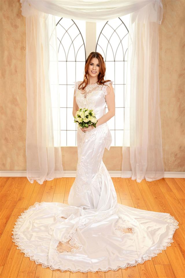Portrait Bride Standing In Front Of Window