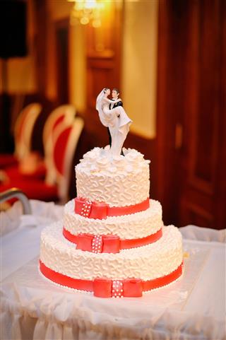 White Wedding Cake With Red Ribbons