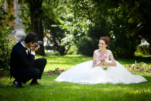 Groom photographing his bride