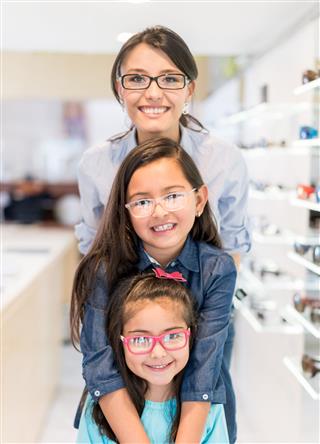 Mother And Daughters Wearing Glasses