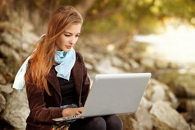 Girl Using Laptop In The Nature