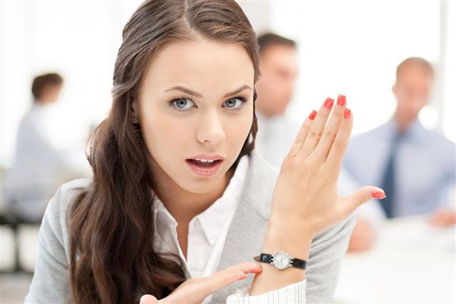 Businesswoman Pointing At Her Watch