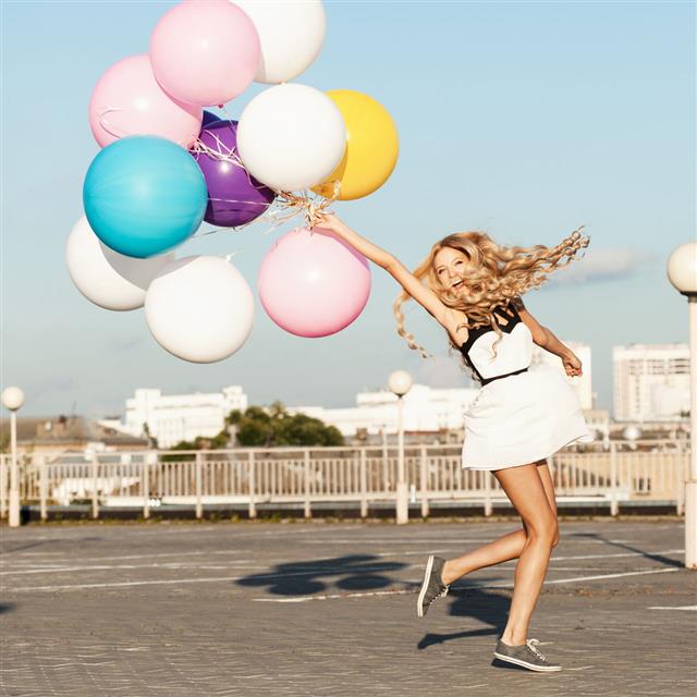Happy Woman With Colorful Latex Balloons