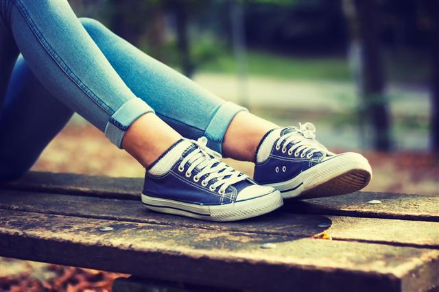 Woman In Jeans And Blue Sneakers