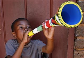 African Boy Blowing A Vuvuzela